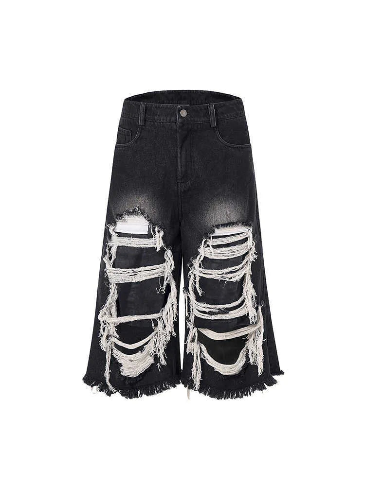 Black cropped wide-leg jeans with mid-high waist and ripped patch details on cotton denim fabric