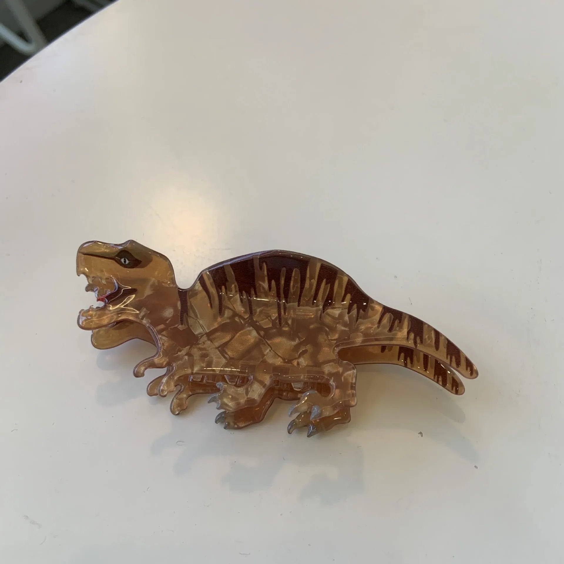 Dinosaur acrylic jaw hair clip showing grip mechanism and detailed dinosaur design in available colour options