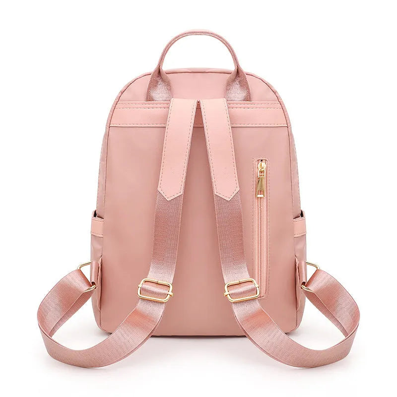 Black women's casual nylon backpack showing square vertical shape with shoulder straps and external pockets
