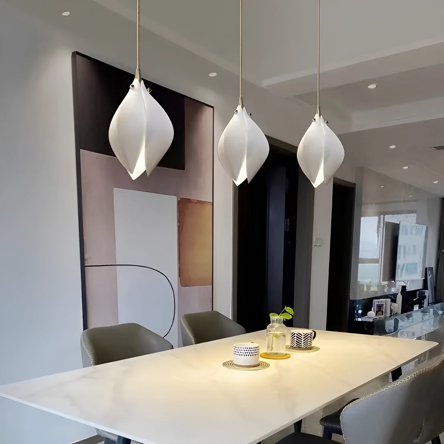 Ceramic magnolia petal-shaped single head pendant light with a dimmable fitting against a neutral background.