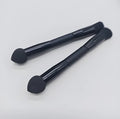 Elegant black double-headed makeup brush with a concealer brush and angled miter sponge on a wooden handle.