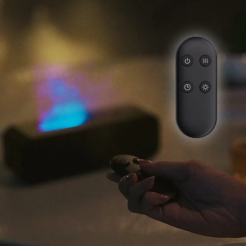 Black and white aroma diffuser with flame animation and coloured LED lights on a wooden table.
