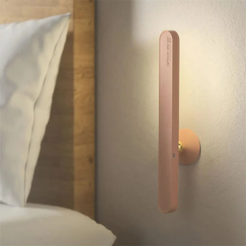 White geometric desk lamp with USB cable and magnetic base for wall mounting.