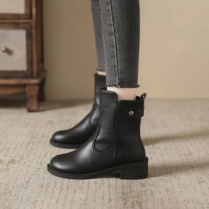 Black women's ankle boots with side zip and low round toe on a rubber sole.