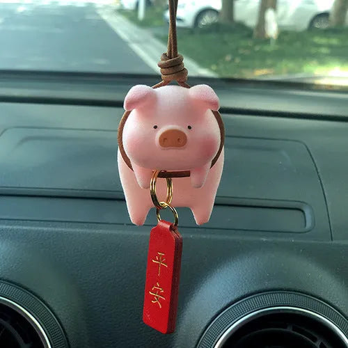 Colourful 3D resin cartoon pig figurine car decoration on a car dashboard