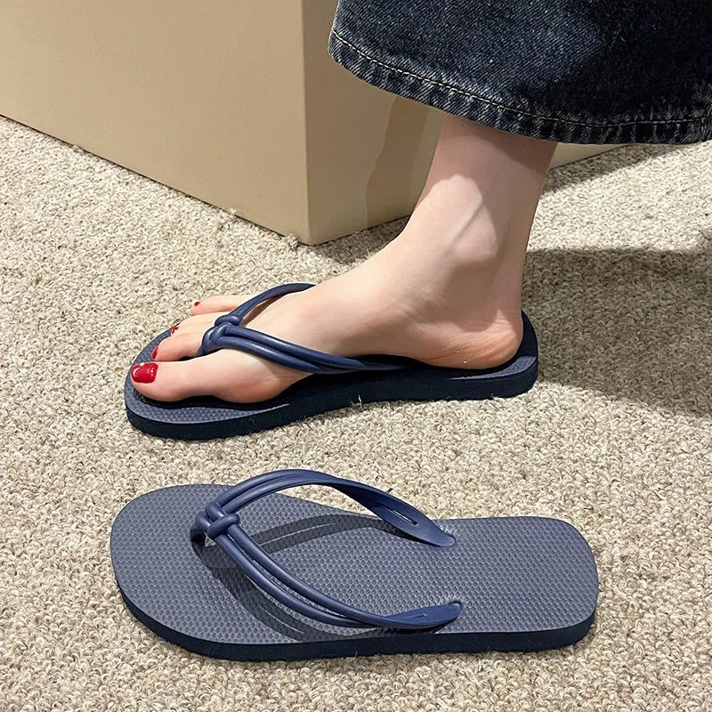 Men's casual flip flops with toe covering in PVC material, showing non-slip sole pattern and full foot enclosure design