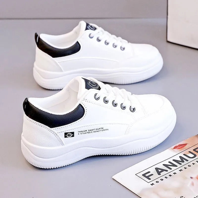 Women's white Korean-style casual shoes with cross strap detail and a synthetic leather upper.