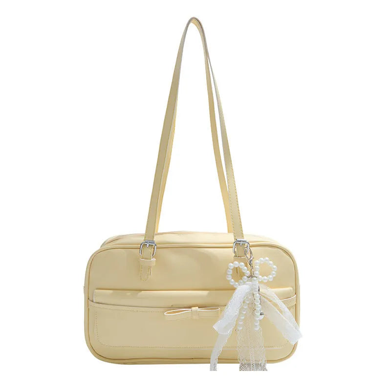 Structured PU leather single-shoulder flap bag in a horizontal square shape with a flap closure.