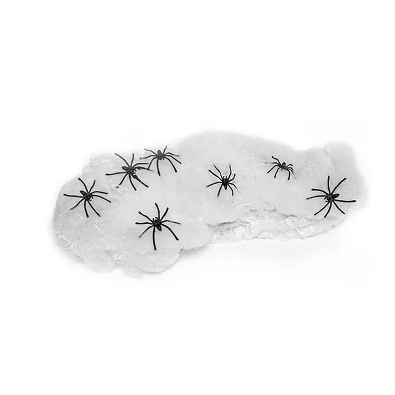 White cotton spider web Halloween decoration bundle with plastic spiders scattered on a dark background.