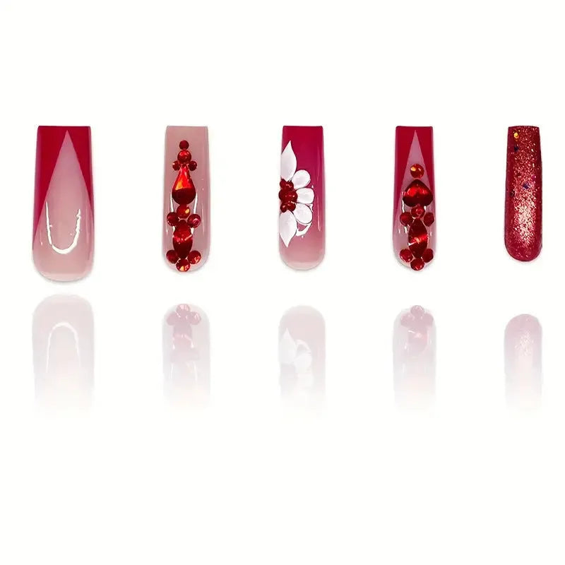 Long European square fake nails with red diamond and flower pattern design, shown with glue and file