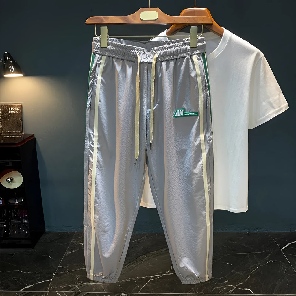 Man wearing grey cotton harem pants with a mid-waist and loose-fitting trousers-length legs.