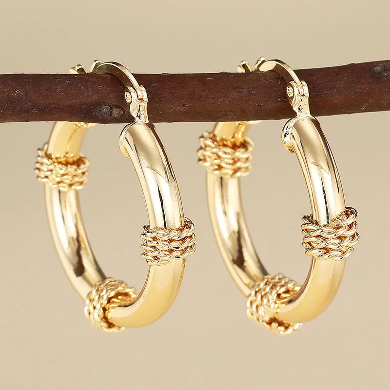 Geometric copper earrings with ring and line design in golden colour