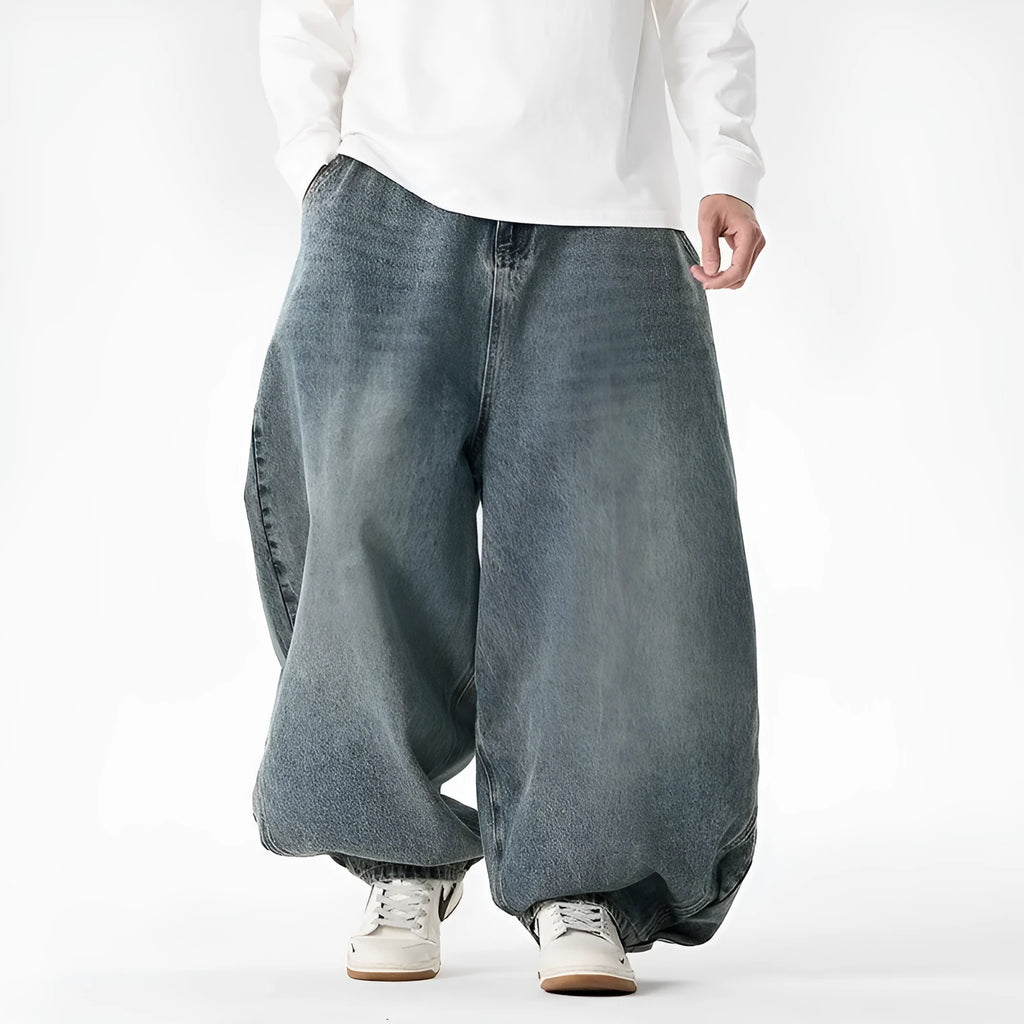 Men's plus size light blue wide leg baggy denim jeans with a low waist and straight leg opening.
