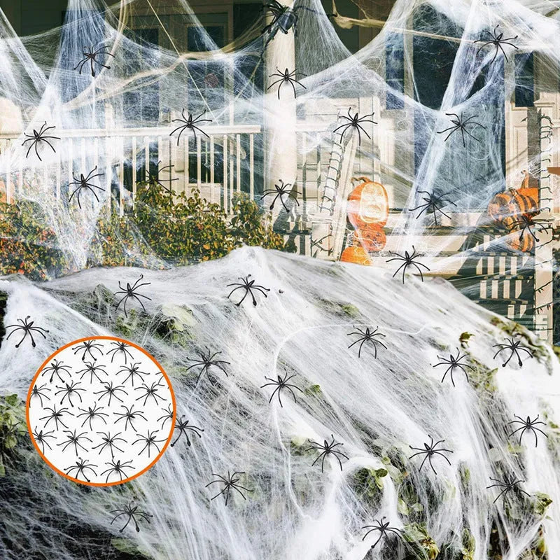 White cotton spider web Halloween decoration bundle with plastic spiders scattered on a dark background.