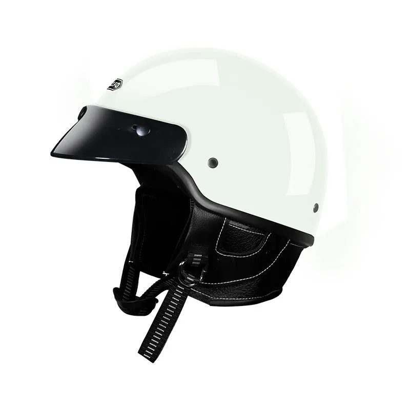 Retro style motorcycle helmet in matte black on a stand, showing classic biker design.