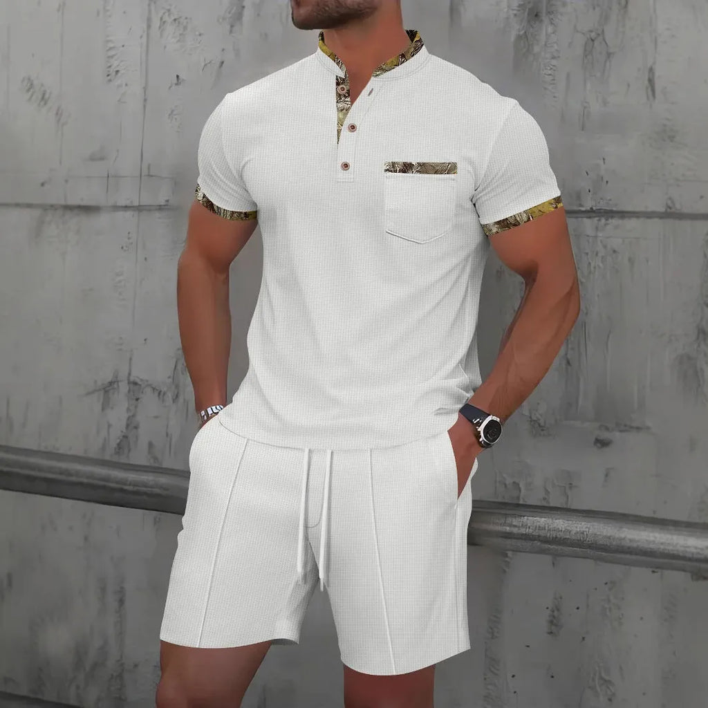 Man wearing a grey zip-front polo collar short sleeve top and matching shorts from a cotton blend suit set.