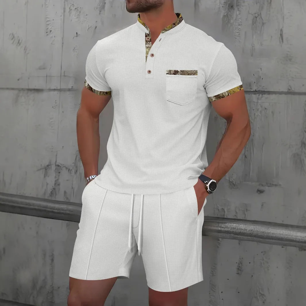 Man wearing a grey zip-front polo collar short sleeve top and matching shorts from a cotton blend suit set.