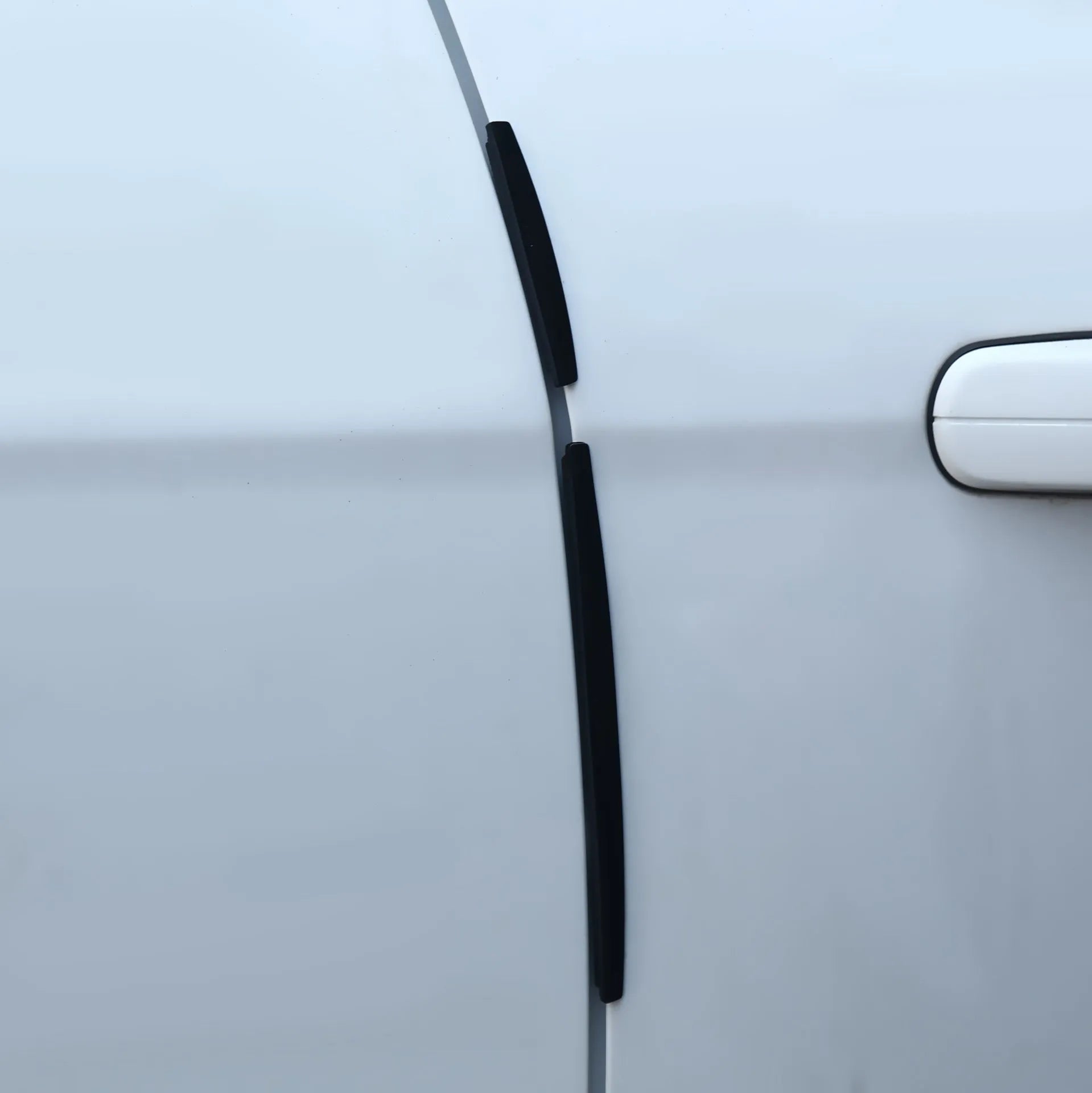 Solid white plastic car door edge guard bumper strip for vehicle side protection.