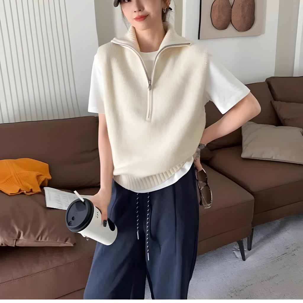 Orange sleeveless half-zip mesh knit vest on a hanger, casual style.