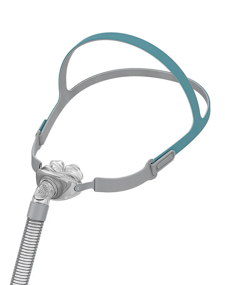 Ventilator nasal pillow mask with silicone cushion and headband components displayed in English packaging