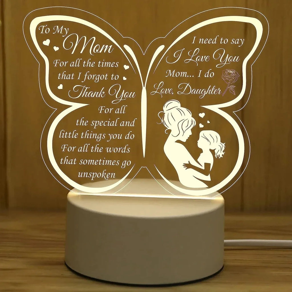 White heart-shaped acrylic table lamp with touch control base on a wooden surface