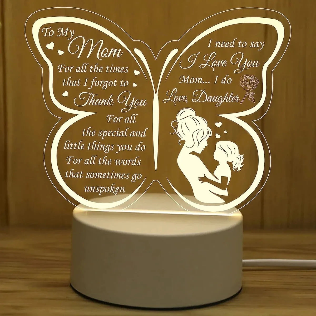 White heart-shaped acrylic table lamp with touch control base on a wooden surface
