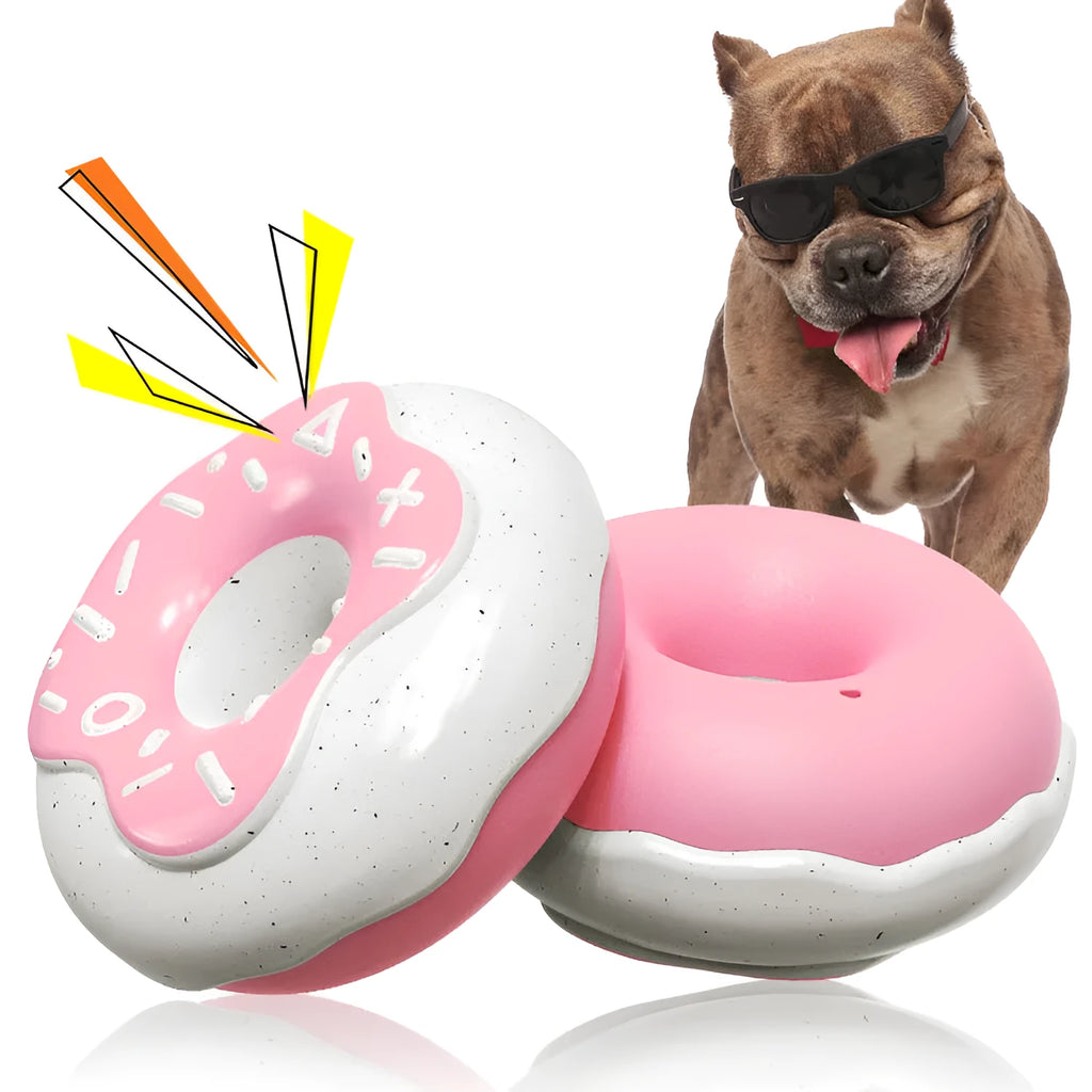 Pink donut-shaped dog chew toy with textured surfaces for dental cleaning
