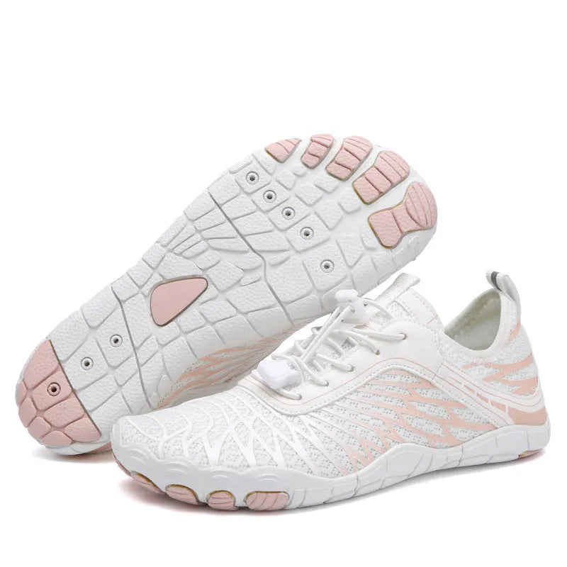 White and black lace-up casual trainers with rubber soles on a plain background