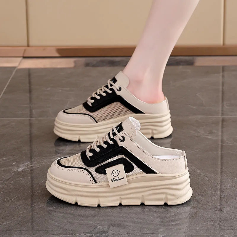 Women's black mesh half slippers with round toe and rubber sole on a white background