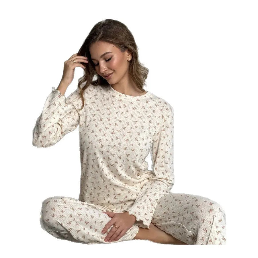 White floral print women's sleepwear set with long bell sleeve top and wide-leg trousers.