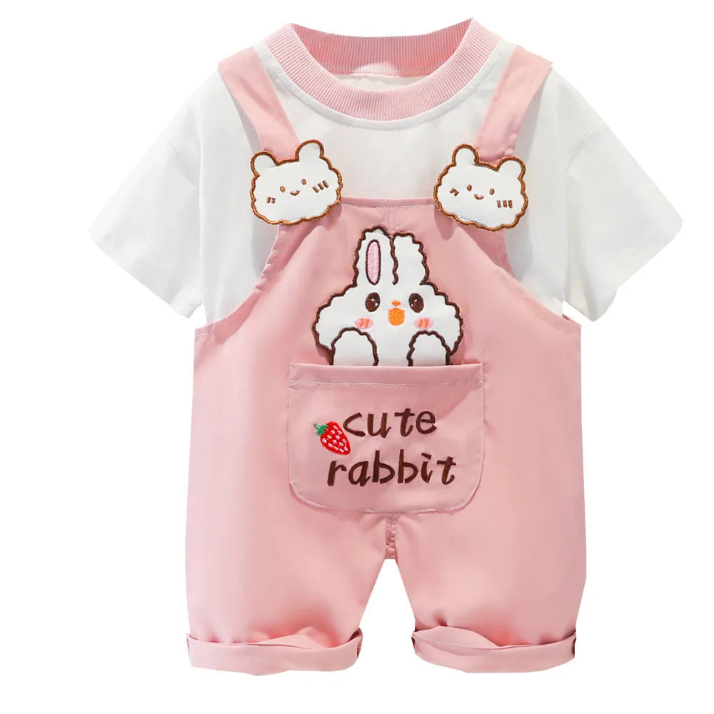 Baby wearing yellow cotton short-sleeved overalls with a cartoon print and openable straps.