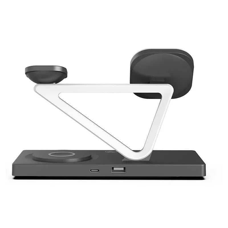 White 5-in-1 wireless charging station with magnetic phone holder, smartwatch pad, and glowing RGB night light on a wooden desk.