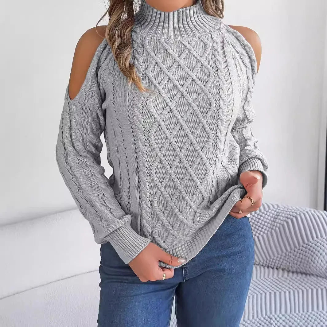 Woman wearing a gray twisted pattern sweater with a strapless half-high collar and long lantern sleeves.