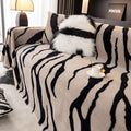 Zebra pattern flannel sofa slipcover in caramel colour, shown on a grey sofa