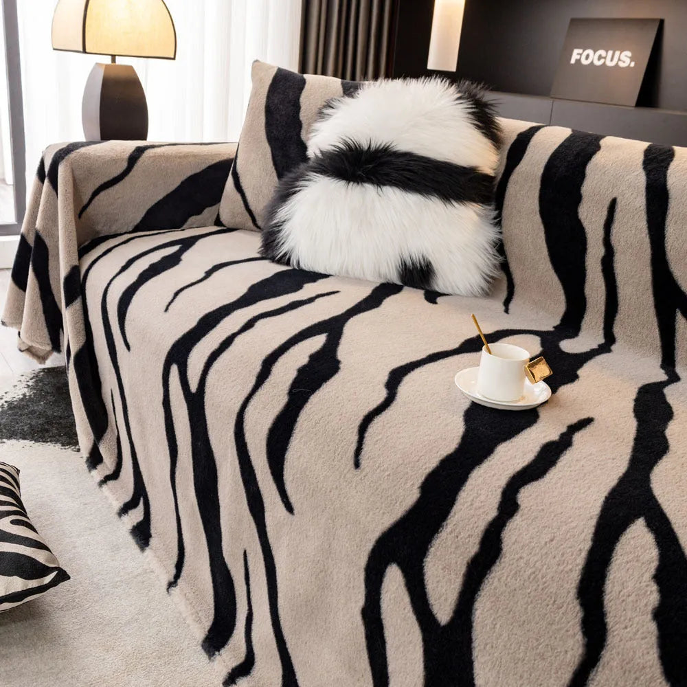 Zebra pattern flannel sofa slipcover in caramel colour, shown on a grey sofa