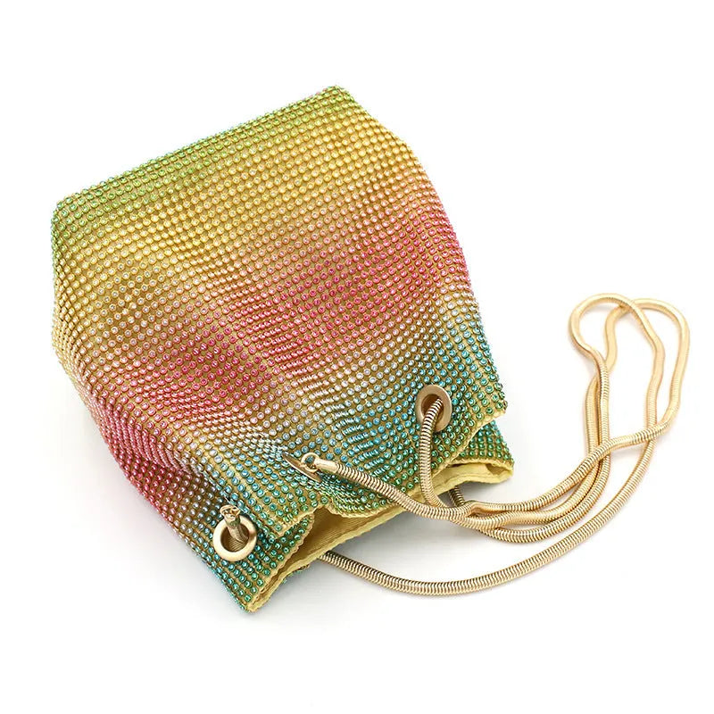 Rainbow rhinestone bucket bag with glittering crystals and a metal chain strap.
