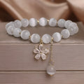 Women's white cat's eye stone bracelet with flower tassel pendant and safety buckle clasp