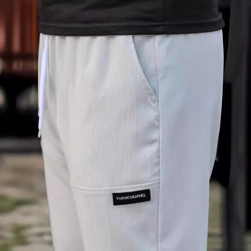 Men's polyester trousers for spring and autumn in light grey, shown in size M.