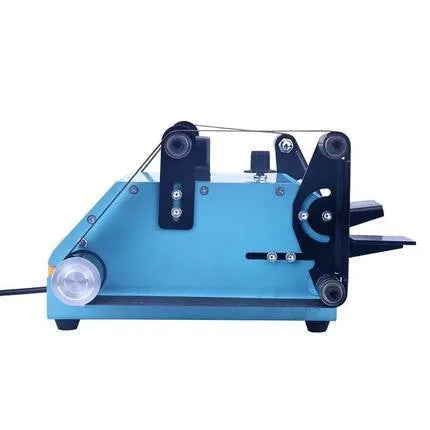 Blue desktop dual-axis belt sander with variable speed control and included knife sharpening tool on a workbench.