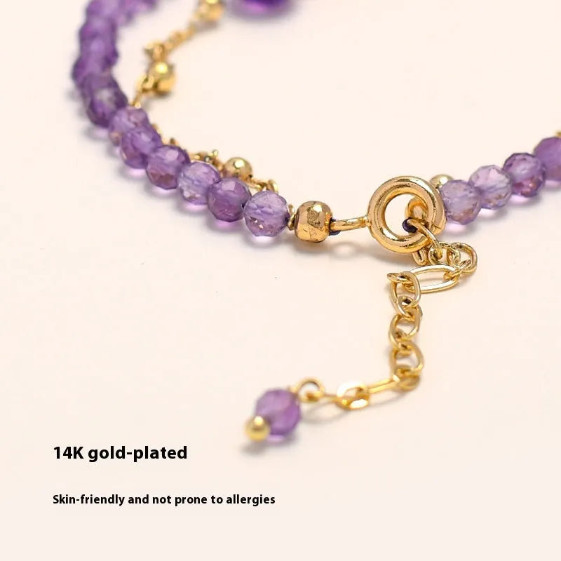 Close-up of a women's amethyst crystal bracelet with a diamond shape and Chinese style design.