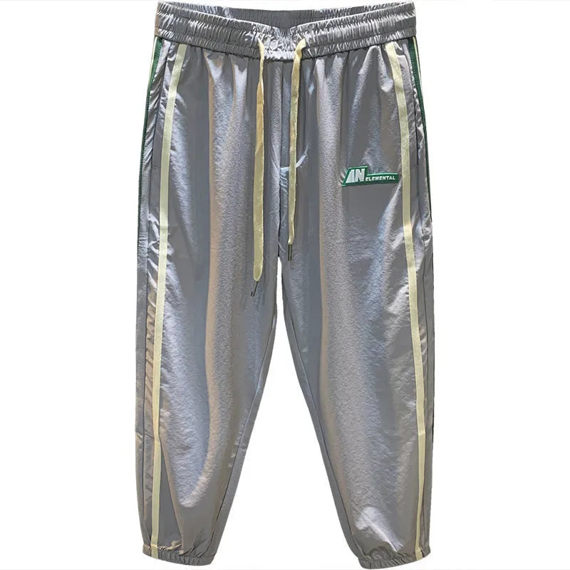 Man wearing grey cotton harem pants with a mid-waist and loose-fitting trousers-length legs.