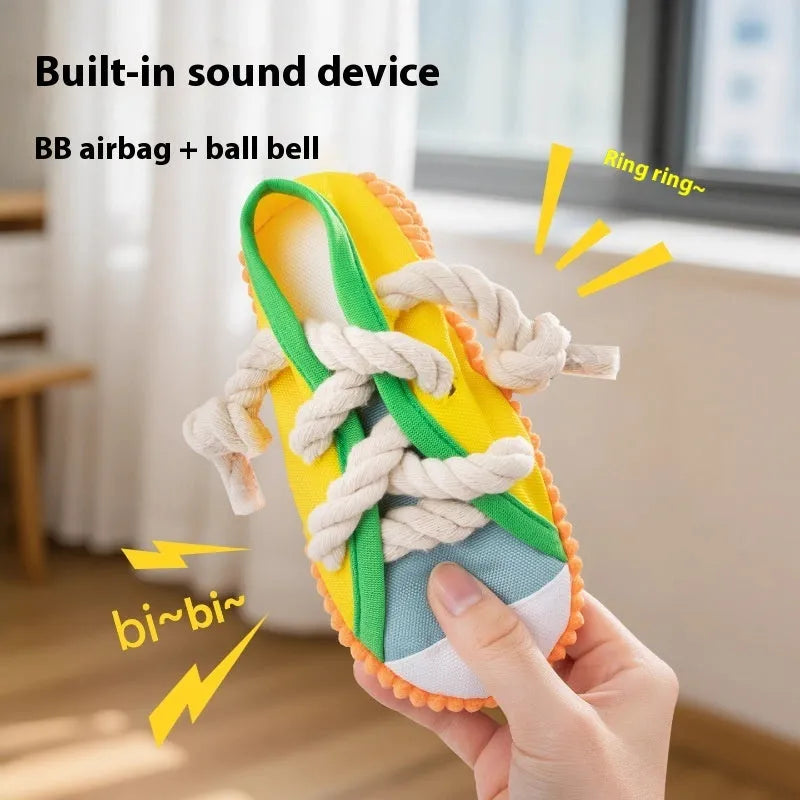 Slipper-shaped plastic dog chew toy in three colours with bends for chewing