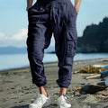 Men's casual linen trousers with ankle-tied cuffs and multi-pocket design in solid colour