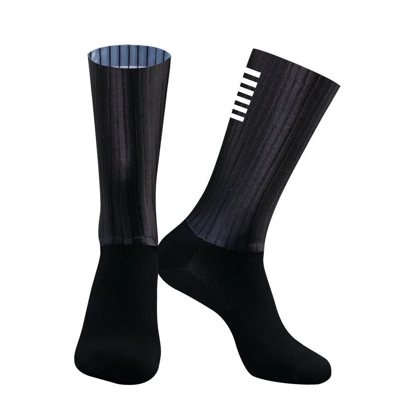 A pair of athletic cycling and running socks in a moisture-wicking fabric blend on a grey background.