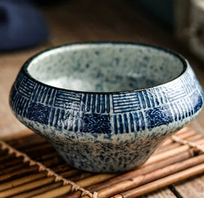 Ceramic tall Japanese soup noodle bowl in a retro glaze colour on a wooden table.
