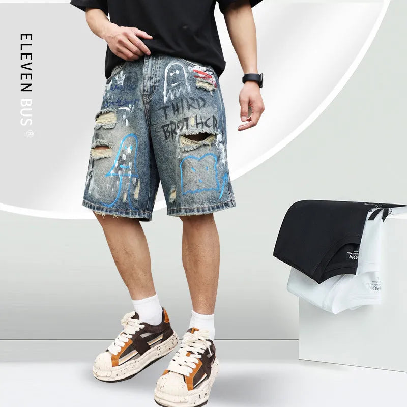 Blue ripped men's denim shorts with graffiti design and zipper fly