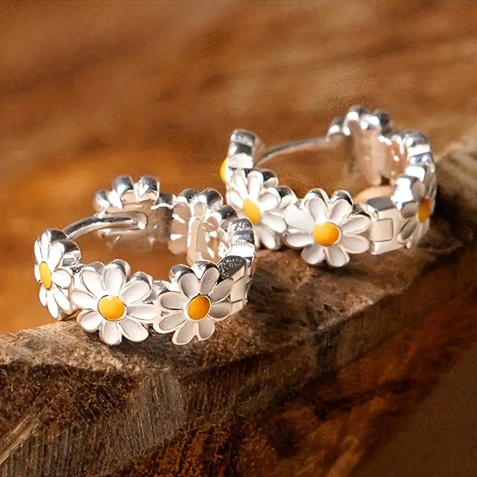 Pair of white daisy flower-shaped ring earrings with a gem inlay detail.