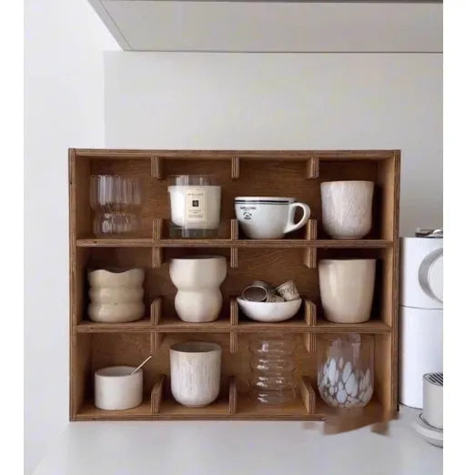 Square solid wood storage rack with multiple grid compartments for cups in a birch wood finish.