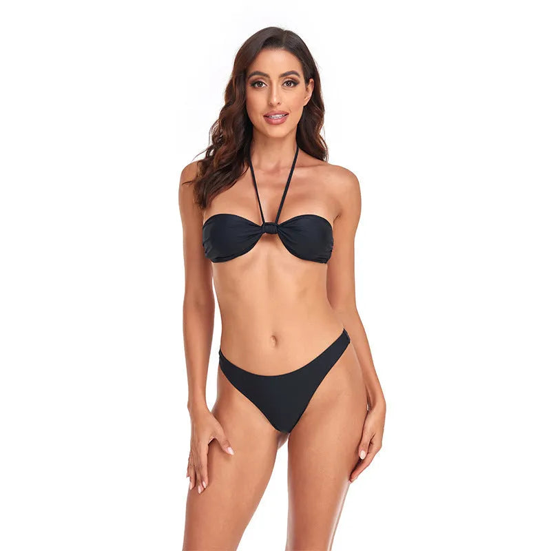 Black women's bikini set with lace-up tube top and briefs on a neutral background.