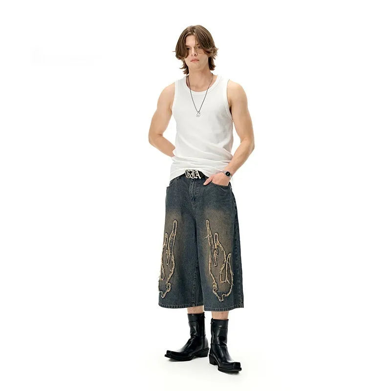 Men's black denim shorts with red flame embroidery patches on legs